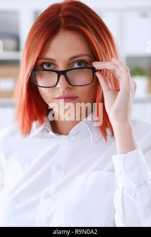 Red haired business woman with glasses Stock Photo