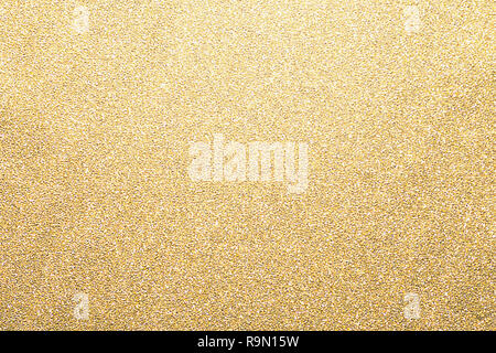 Gold glitter background, shiny wrapping paper defocused Stock Photo