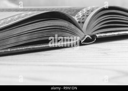 open book on the wooden table with copy space, selective focus and shallow depth of field, black white photography Stock Photo