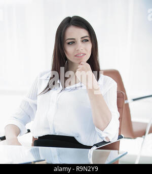 serious business woman sitting at the Desk in the office Stock Photo