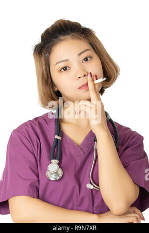 Beautiful Asian doctor or nurse smoking a cigarette isolated on a white background Stock Photo