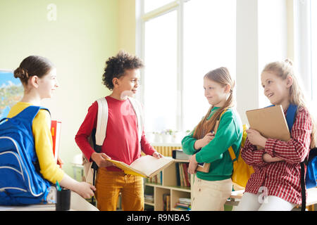Elementary students discussing school project Stock Photo