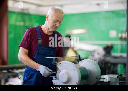 Man working on lathe machine Stock Photo