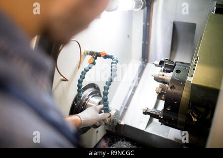 Man working on lathe machine Stock Photo