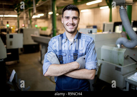 Young engineer standing in factory Stock Photo