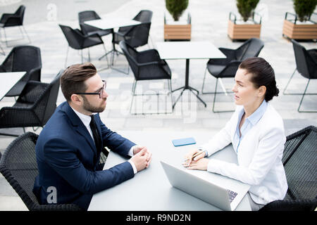 Communicating man and woman on business meeting Stock Photo