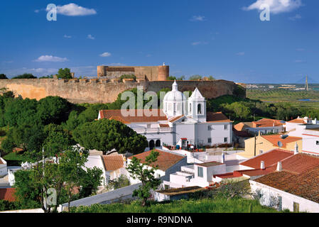 View of historic small town with medieval castle and white washed church Stock Photo