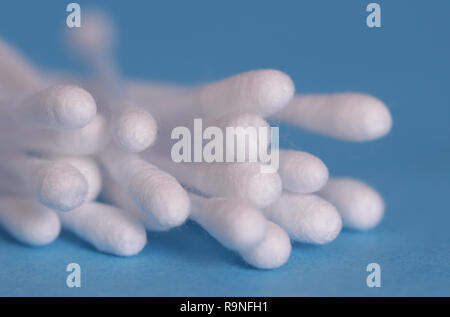 Cotton swabs isolated on blue background Stock Photo