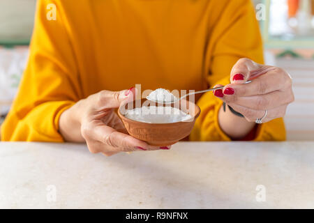 Woman hand holding spoon full of sugar health care concept. Stock Photo