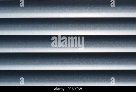 Abstract of monochrome metal blinds with a straight horizontal view, showing contrasting highlights and shadows. Stock Photo