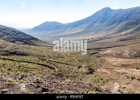 Hiking on Jandia Peninsula, Fuerteventura, Canary Islands, Spain. Mountains in this area (Jandia Massif) divided by deep valleys (barrancos). Fuerteve Stock Photo