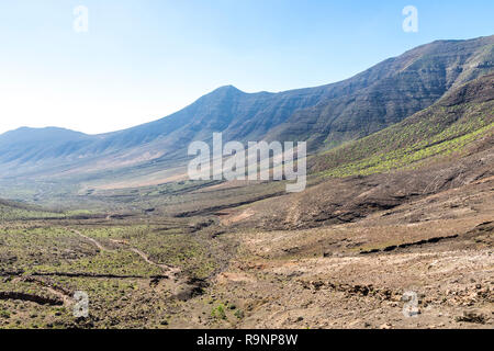 Hiking on Jandia Peninsula, Fuerteventura, Canary Islands, Spain. Mountains in this area (Jandia Massif) divided by deep valleys (barrancos). Fuerteve Stock Photo