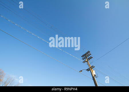 Electric and telephone power line, old and outdated, on a rotten wooden pole, abiding by North American standards, in the city of Ottawa, Ontario, Can Stock Photo
