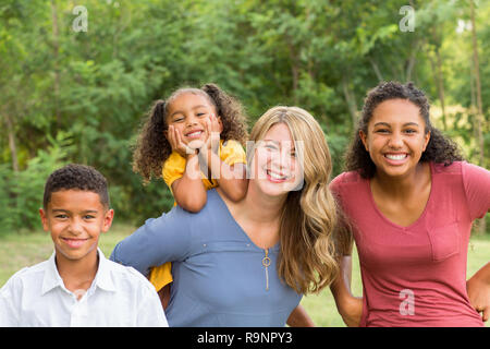 Portarit of a happy mixed race family smiling Stock Photo