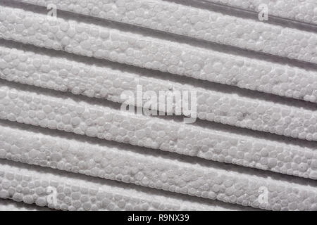 Stack of polystyrene foam - used as foam packaging or ceiling tiles. Metaphor layers, levels, rough surface, insulation foam. Stock Photo