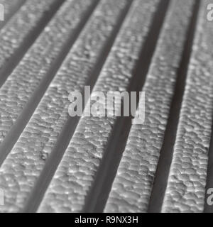 Stack of polystyrene foam - used as foam packaging or ceiling tiles. Metaphor layers, levels, rough surface, insulation foam. Stock Photo