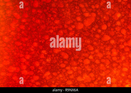 Macro close-up of artificial polymer sponge pores (maybe polyester or polypropylene). For sponging, cleaning, absorbing, war on plastic, red anger Stock Photo