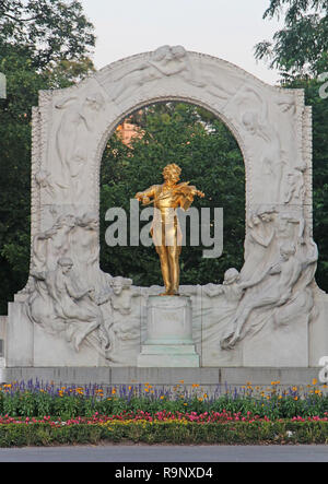 VIENNA, AUSTRIA - JULY 11, 2015: Famous golden statue of composer Johann Strauss II playing his violin in the Stadtpark, Vienna by Edmund Hellmer Stock Photo