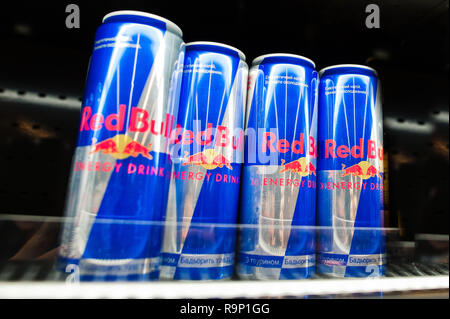 Kyiv, Ukraine - December 19, 2018: Red Bull cans on shelves of fridge in a supermarket. Red Bull is an energy drink sold by Red Bull GmbH, an Austrian Stock Photo