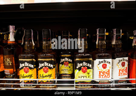 Kyiv, Ukraine - December 19, 2018: Bottles of Jim Beam Honey, Apple and Red Stag on shelves in a supermarket. Jim Beam is a brand of bourbon whiskey p Stock Photo