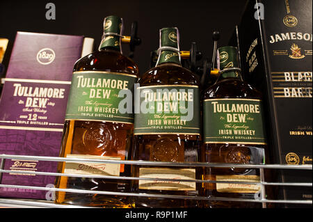 Kyiv, Ukraine - December 19, 2018: Bottles of Tullamore Dew on shelves in a supermarket. Tullamore D.E.W. is a brand of Irish whiskey produced by Will Stock Photo