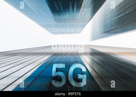 5G on motion blurred skyscrapers low angle view against white sky Stock Photo