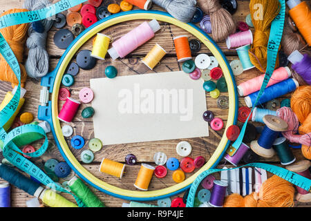 Sewing tool for needlework, colored threads centimeter and buttons with a pair of scissors on the table Copy space Stock Photo