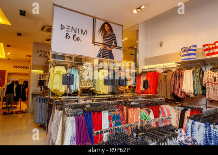 COLOMBO, SRI LANKA - SEPTEMBER 05, 2016:  Wide View of Ladies wear Clothes, Dresses, Skirts, Frocks, Trousers, Jackets, with Shelves, Racks and Hanger Stock Photo