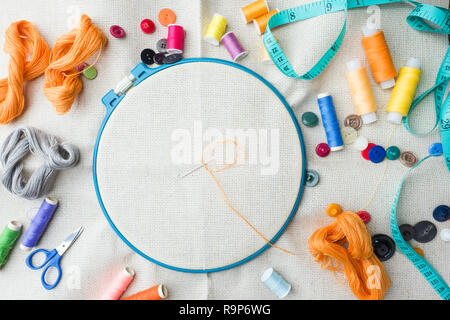 Embroidery set. White linen fabric, embroidery hoop, colorful threads and needls. Copy space Stock Photo