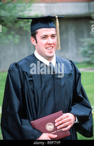 Happy graduate student holding a diploma isolated on white background ...