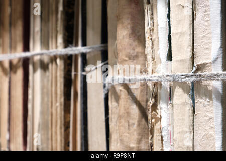 close-up old books tied with a rope on wooden shelf  in the Library or in the archive Stock Photo