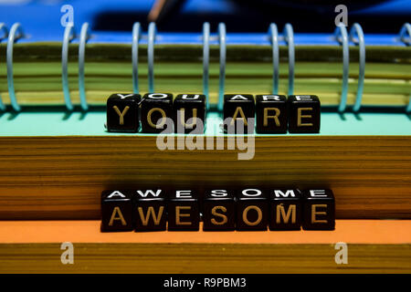 You are awesome on wooden blocks. Education and business concept on wooden background Stock Photo