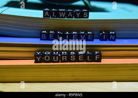 Always believe in yourself written on wooden blocks. Education and business concept on wooden background Stock Photo