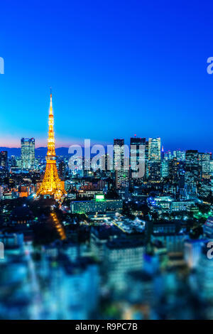 Asia Business concept for real estate and corporate construction - city view and tokyo tower under neon night in tokyo, Japan with tilt shift, miniatu Stock Photo