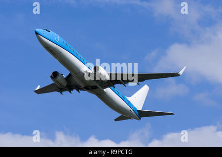 Airplane in flight viewed from the ground Stock Photo