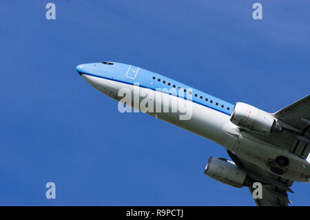 Airplane in flight viewed from the ground Stock Photo