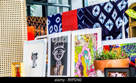 various art work; paintings and traditional clothes displayed Stock Photo