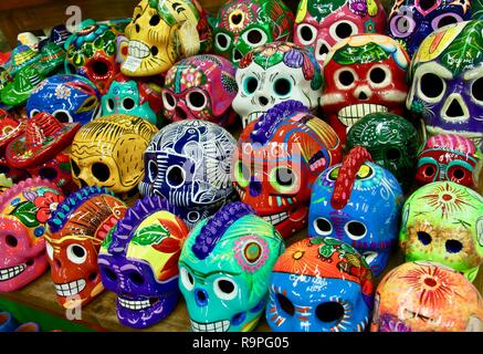 Brightly coloured and decorated skulls as souvenirs in Mexico Stock Photo