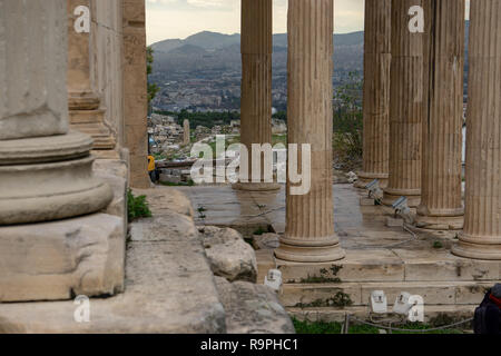 Seeing the city of Athens from atop of Acropolis through the marble ancient columns instantly made all the pains of travel disappear. Stock Photo