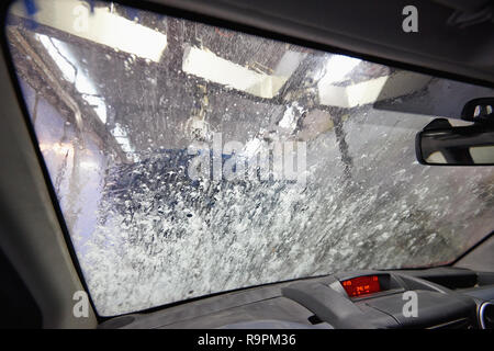 Automatic carwash tunnel station view from inside car Stock Photo