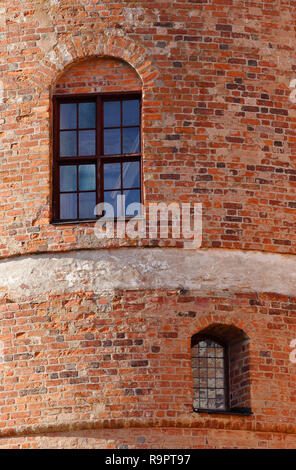 Two windows in the red brick wall in one of the castle towers. Stock Photo