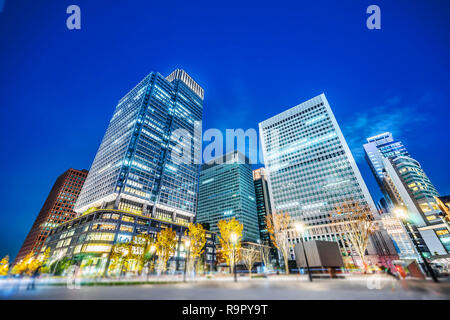 Asia Business concept for real estate and corporate construction - looking up view of panoramic urban city skyline view under blue night in tokyo, Jap Stock Photo
