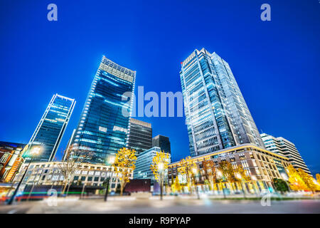 Asia Business concept for real estate and corporate construction - looking up view of panoramic urban city skyline view under blue night in tokyo, Jap Stock Photo