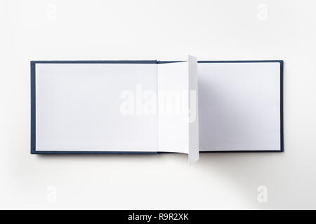 Design concept - Top view blue hardcover notebook with open & flip curl rolled page isolated on background for mockup Stock Photo