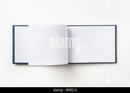 Design concept - Top view blue hardcover notebook with open & flip curl rolled page isolated on background for mockup Stock Photo