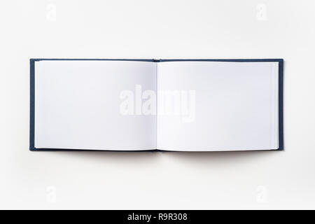 Design concept - Top view blue hardcover notebook with open & flip curl rolled page isolated on background for mockup Stock Photo