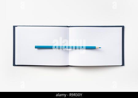 Design concept - Top view of blue hardcover notebook and pencil isolated on background for mockup Stock Photo