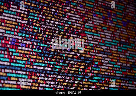 Software developer programming code on computer. Abstract computer script source code. Shallow depth of field, selective focus effect Stock Photo