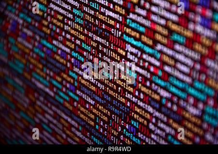 Software developer programming code on computer. Abstract computer script source code. Shallow depth of field, selective focus effect Stock Photo