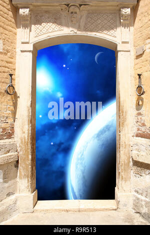 Frame with ancient door and space scene with planet, stars and nebula Stock Photo